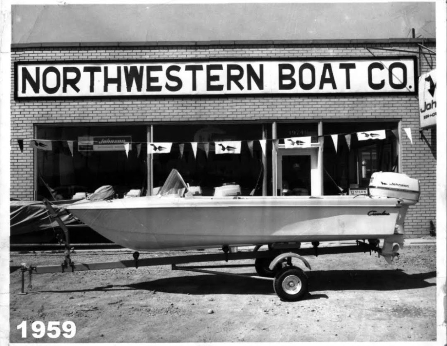 Northwestern Boat Company storefront in 1959 with a Johnson-powered boat